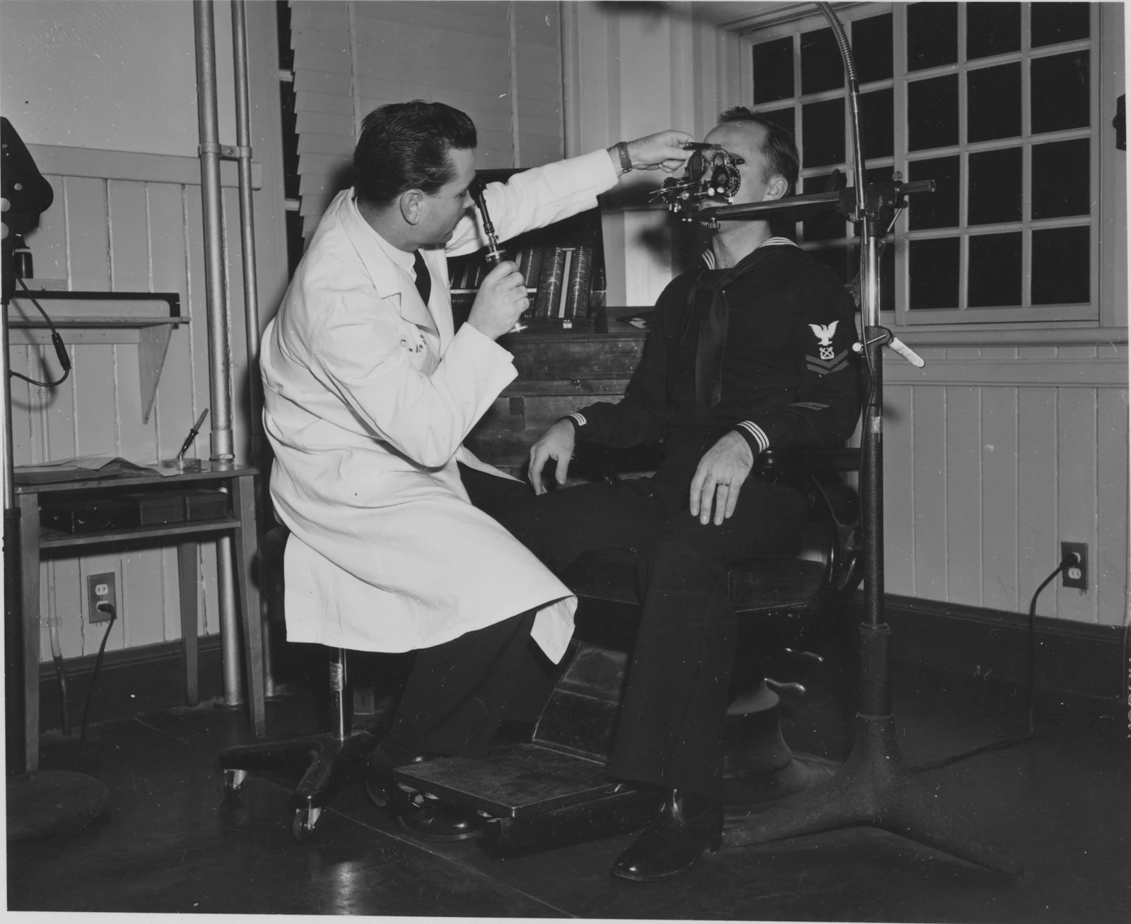 Doctor examines patient's eye with equipment